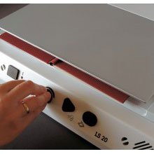 A white device with tuning buttons and document scanner on the top.