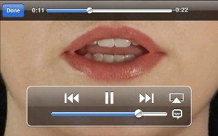 Close-up picture of a woman's singing and a control panel on the bottom for playing the song.