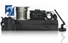 Spool of wire, loop control panel, and microphone cord sitting on black loop pad next to a microphone stand.