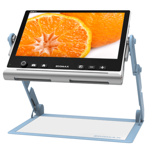 Video display showing a cut orange attached to a stand with a flat surface below.