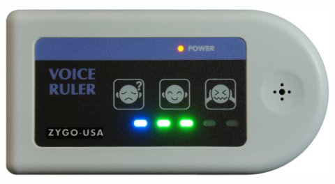 White, rectangular device, rounded at one end, with LED lights along the bottom right and a speaker in the center of the rounded point.
