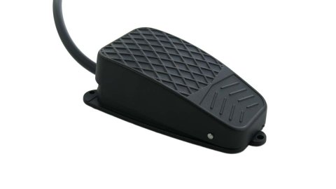 A black rectangular foot pedal with a black cord attached.