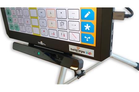 The bottom half of a tablet that is mounted on a tabletop stand with a wide but slim rectangular eye-tracking device attached to its bottom edge. The tracking device has a small green light in its center. The tablet has a USB cord plugged into it. 
