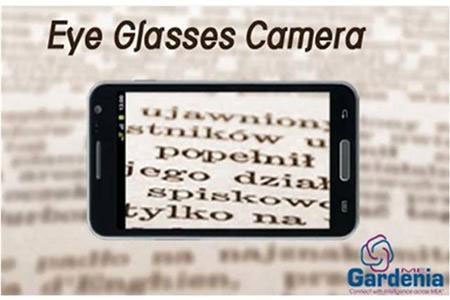 A close-up of a rectangular device resembling a smartphone held out in front of yellow-toned page. The text inside the device is magnified.