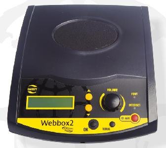 Black device with a small display screen next to a series of buttons and a large dial.