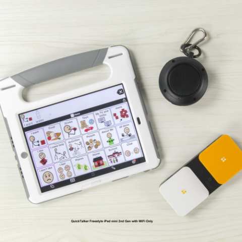 iPad Mini with built-in handle, displaying a grid of pictograms on the screen. Next to it, various switch controls are shown.