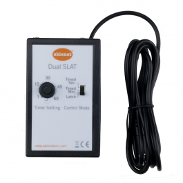 A rectangular black-and-white box with a round control knob and input jack connected.