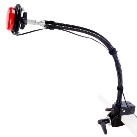 Side view of red switch button attached to a flexible arm and clamped down to a flat surface. 
