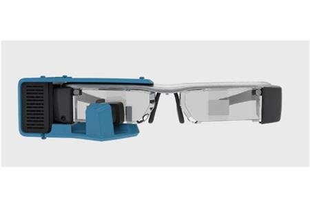 Eyeglasses with attachment on side and bottom of the left lens.