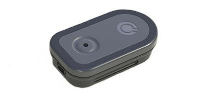 A small dark grey transmitter device that is rectangular in long and oval in shape. 
