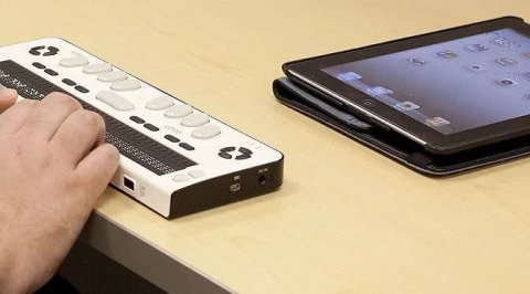 A refreshable braille display connected to an tablet wirelessly.