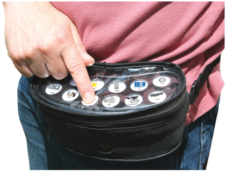 Black pouch that is attached at the waist via a strap. There is a white panel on top of the pouch with 2 rows of six picture symbol buttons.