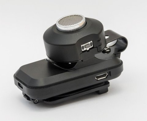 Main body attached to vibrational arm with usb input on the arm and a speaker on the circular part of the device.