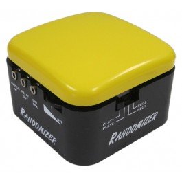 Black cube with jack inputs and volume control on left side and play and record settings on right side. Top of cube is yellow.