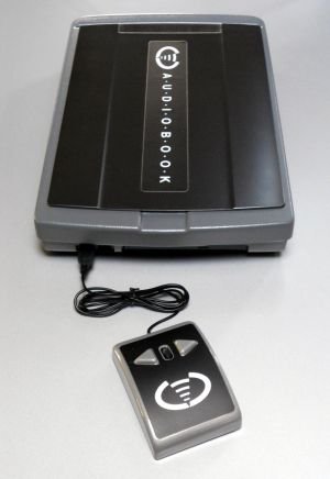Large, rectangular, and black device, with a cord connecting a smaller black device resembling an iPod.