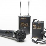 Wireless Audio System consisting of one transmitter, with a clip on lapel mic attached by a cable, a handheld mic, and a dual channel receiver with 2 short antennae.