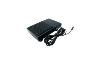 Medium-sized, black, and rectangular device resembling a vehicle foot pedal. The device features a connector cord at the end. 