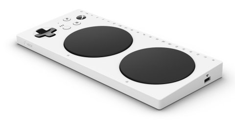 Long, white, and rectangular device that resembles a flat panel. On it are two large round circles that are black in color. There is also a cross-shaped button control (up/down/left/right arrow buttons). 