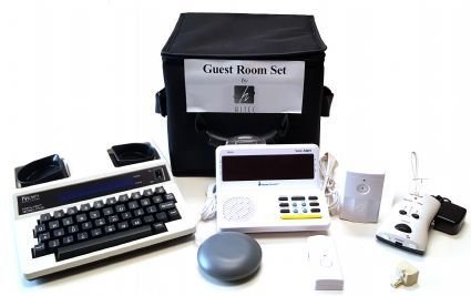 The full range of components in the kit, including a round smoke detector, a TTY with built-in keyboard, and other components.