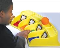 A large, long, and yellow device with four separate divisions, each one with a different illustration and a different-colored switch.
