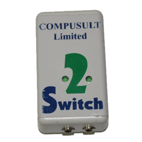 Vertical view of small white rectangular device with 2 Switch written on the top in the middle of two indicator lights and two ports on the end.