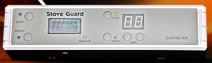 A long, white electronic panel, with a small LCD display and various menu buttons.