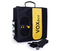 A square device with a handle and strap, control buttons on the side and the product name in a yellow swatch across the front.