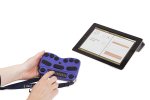 Hands operating the Braille keyboard device beneath a tablet computer screen