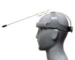 Bust of a head wearing a long white wand with a back tip mounted on a frame.