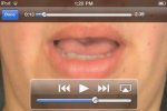 Close-up photo of woman's mouth speaking and a control panel along the bottom.