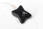 A black star-shaped device with a white cord.