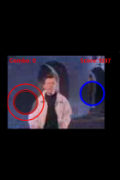 A screenshot of Rick Astley singing with a red circle and a blue circle in the foreground. The score appears at the top right.