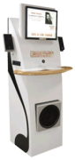 A tall, white terminal with a monitor and speakers at the top, a tray in the middle, and a speaker near the bottom.