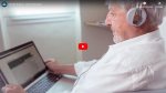 Video thumbnail of a man facing a computer screen with text on it, some of which is highlighted in black.