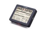 A gray rectangular device featuring a newspaper magnified on the screen.