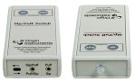 Rectangular unit with control buttons on top, light on top edge, and switch inputs along bottom edge.