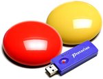 Two round flat wireless switches the size of a billiard ball with a USB drive.