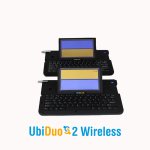 A small, black keyboard device with an LCD screen attached at the top. The LCD screen is split, with a yellow half on top and a purple background at the bottom.