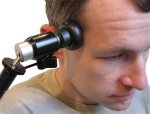 Head pressed against switch attached to mounting device.