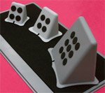Three different-sized gray, wedged switch mounts on black and gray tray.