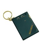 A black, small-to-medium-sized box connected to a keychain with two menu buttons and a speaker.