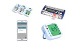 Several different models of medication reminders. One is a smartphone app; another resembles a digital timer. Two models resemble standard pillboxes, but with LCD panels and various menu buttons.