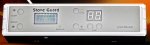 A long, white electronic panel, with a small LCD display and various menu buttons.