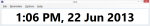 Long, narrow rectangular popup window with time and date displayed in large type.